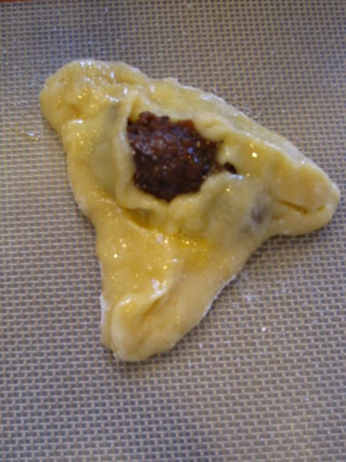Filled dough with egg wash. Author says it is "not pretty."