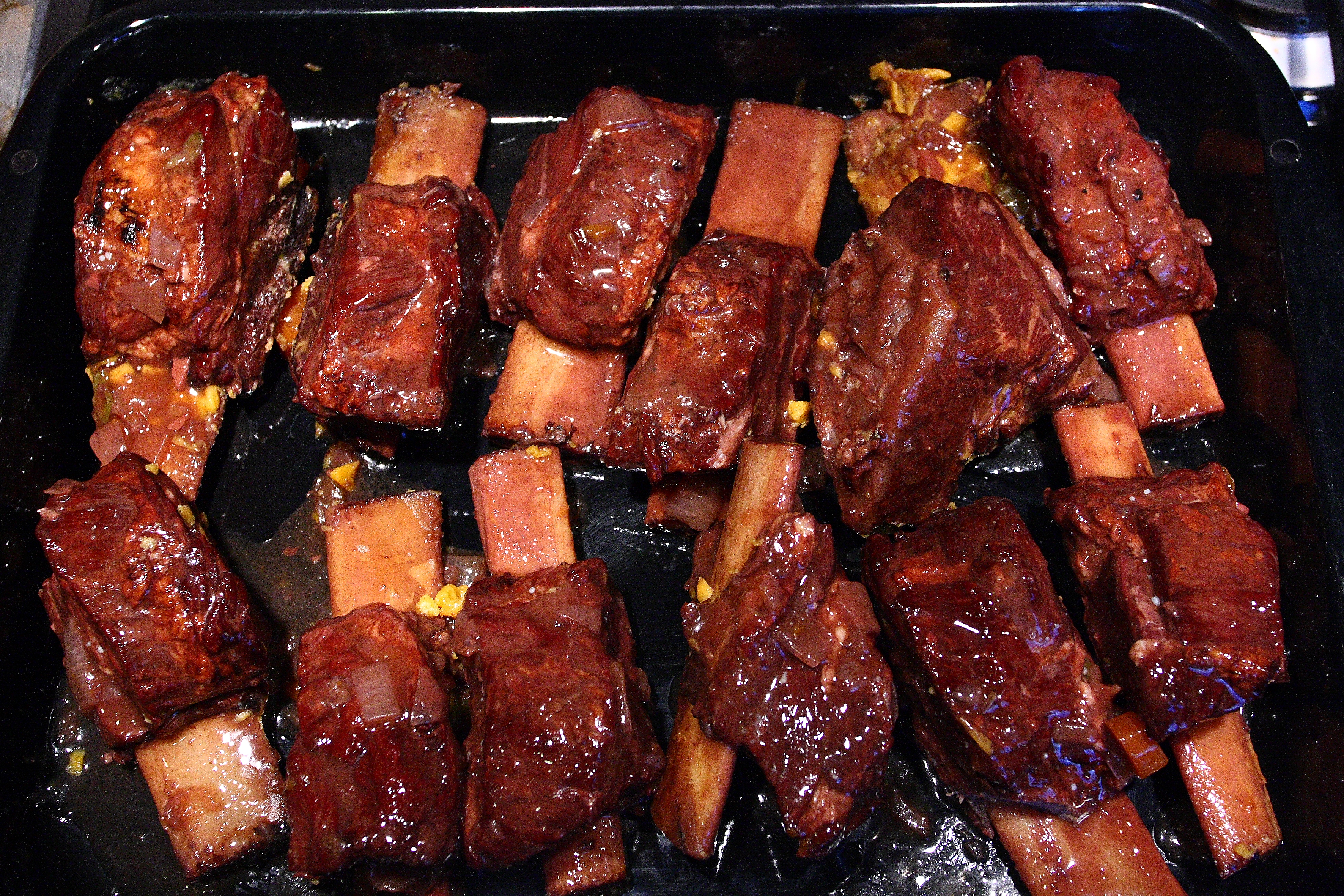 Pan of cooked short ribs preparing to reheat. 