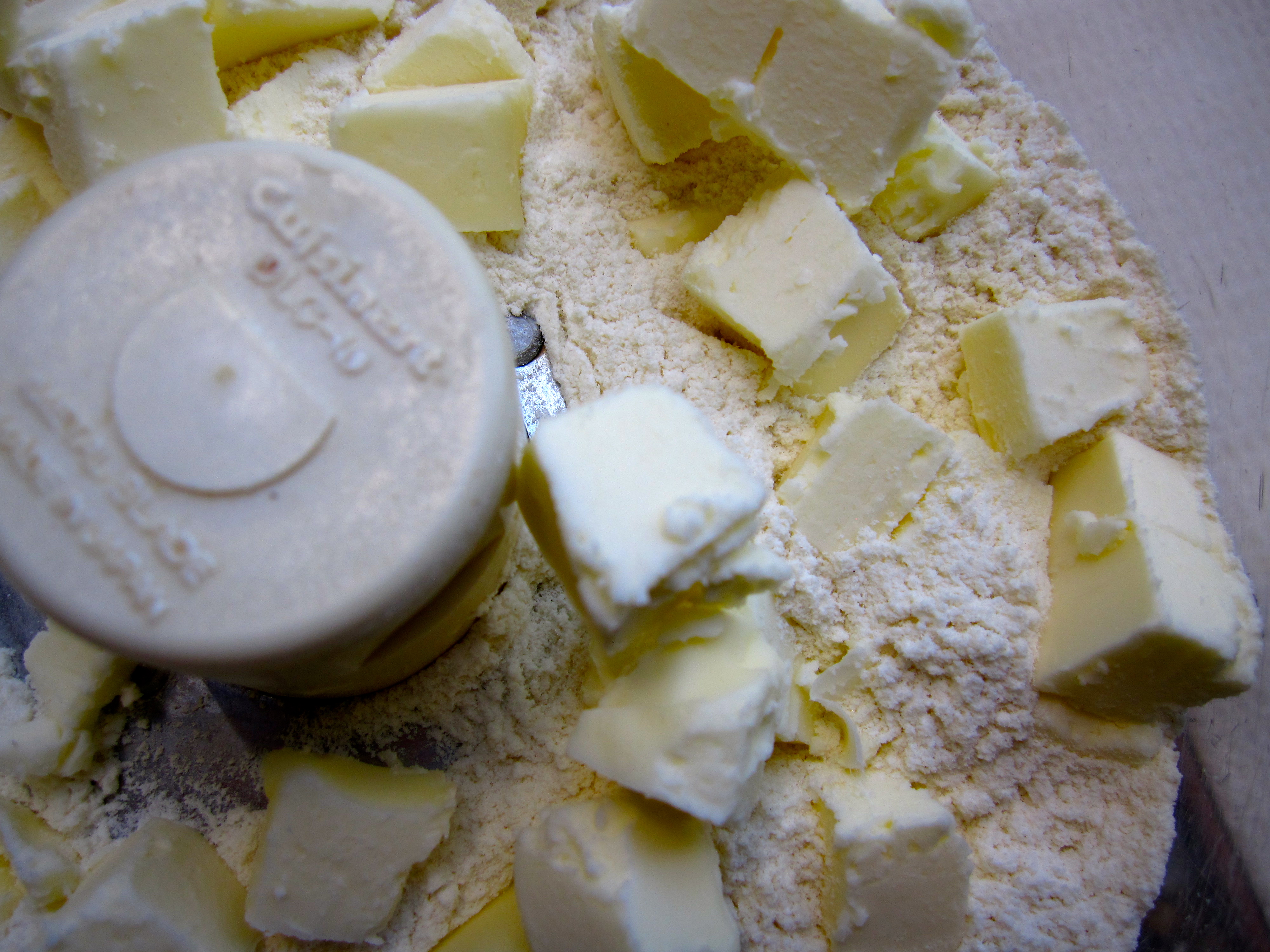 Dorie Greenspan's tart dough with chunks of butter in food processor before processing.