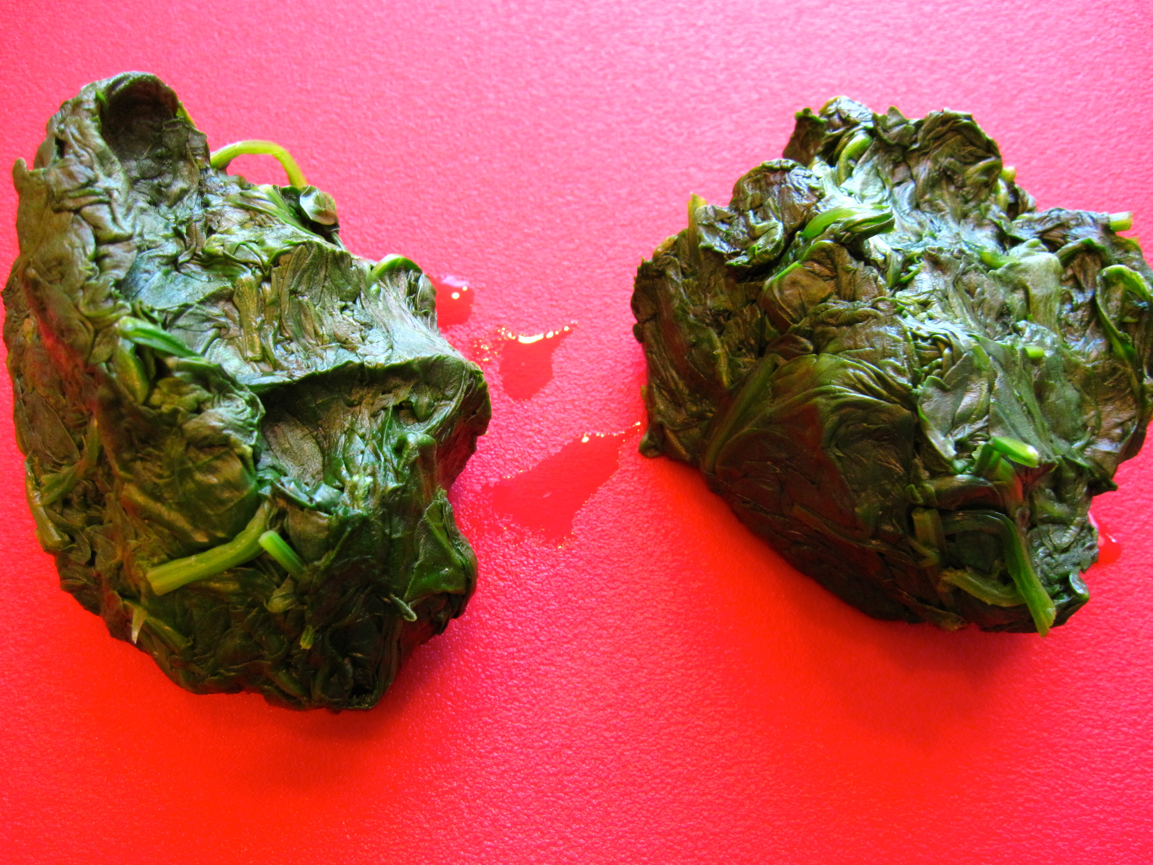 Cooked spinach in squeezed out balls. 
