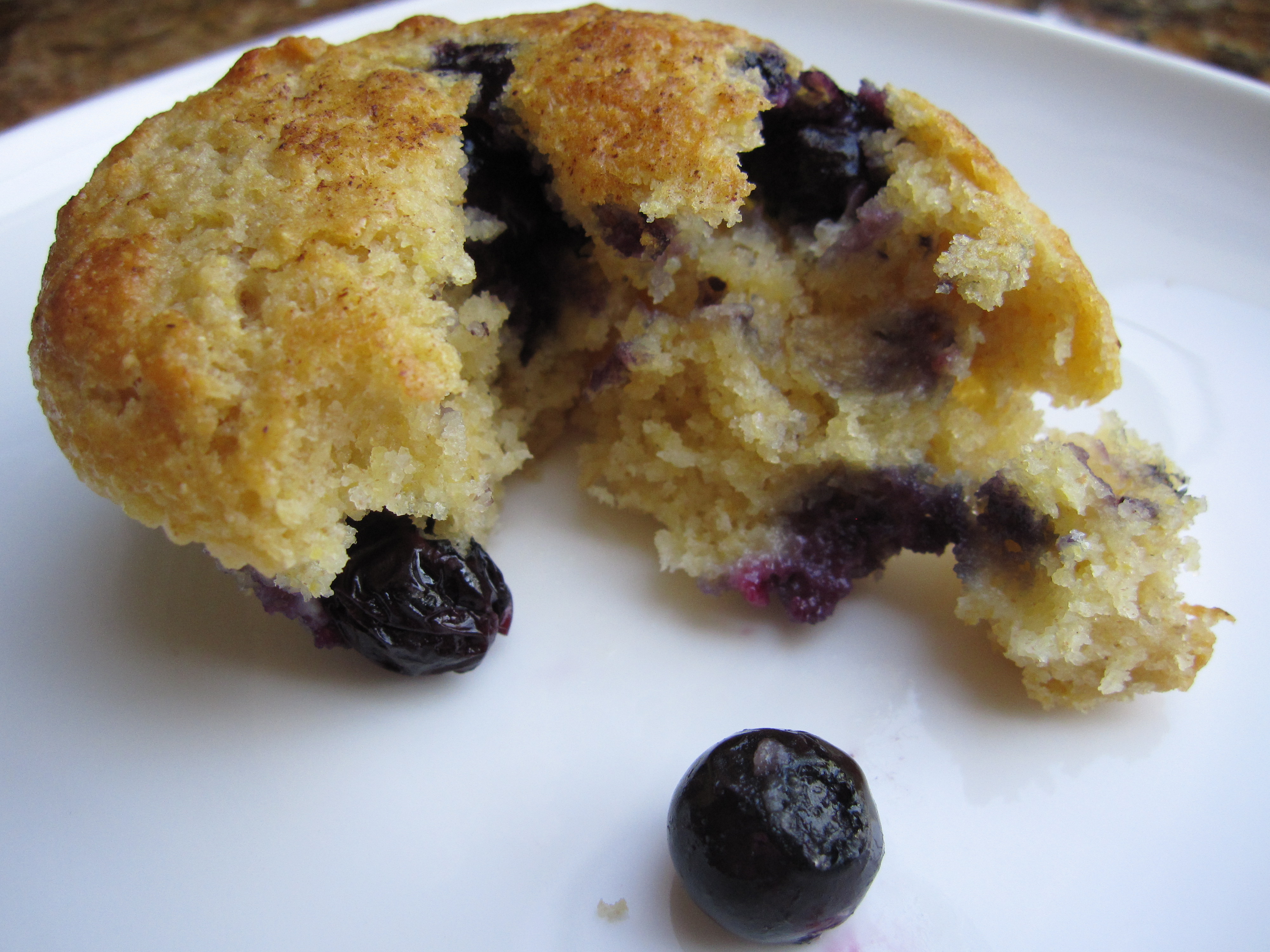 Broken open baked blueberry muffin. 