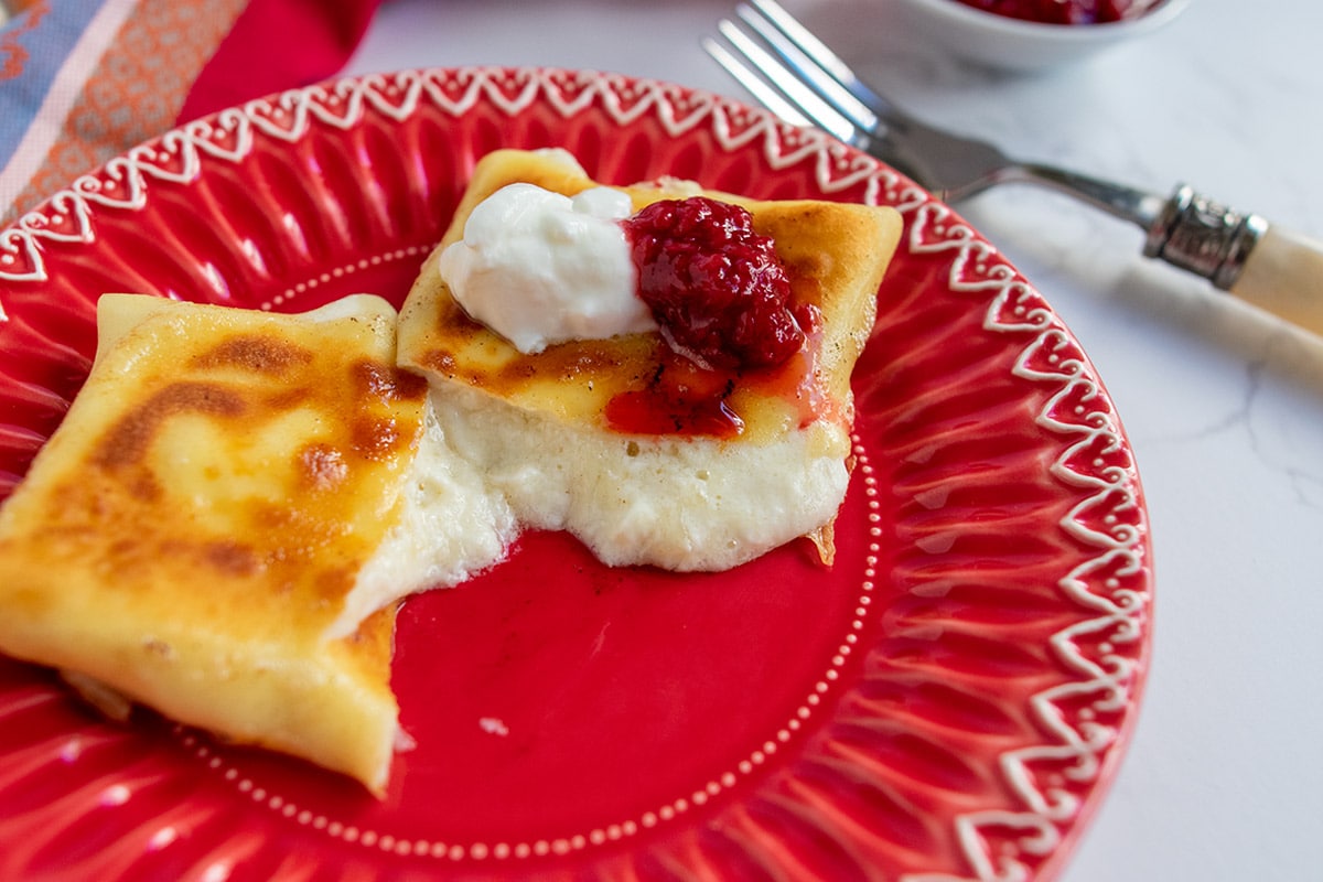 cheese blintz cut open and oozing melty cheese