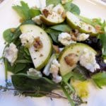 close up of pear salad on white plate