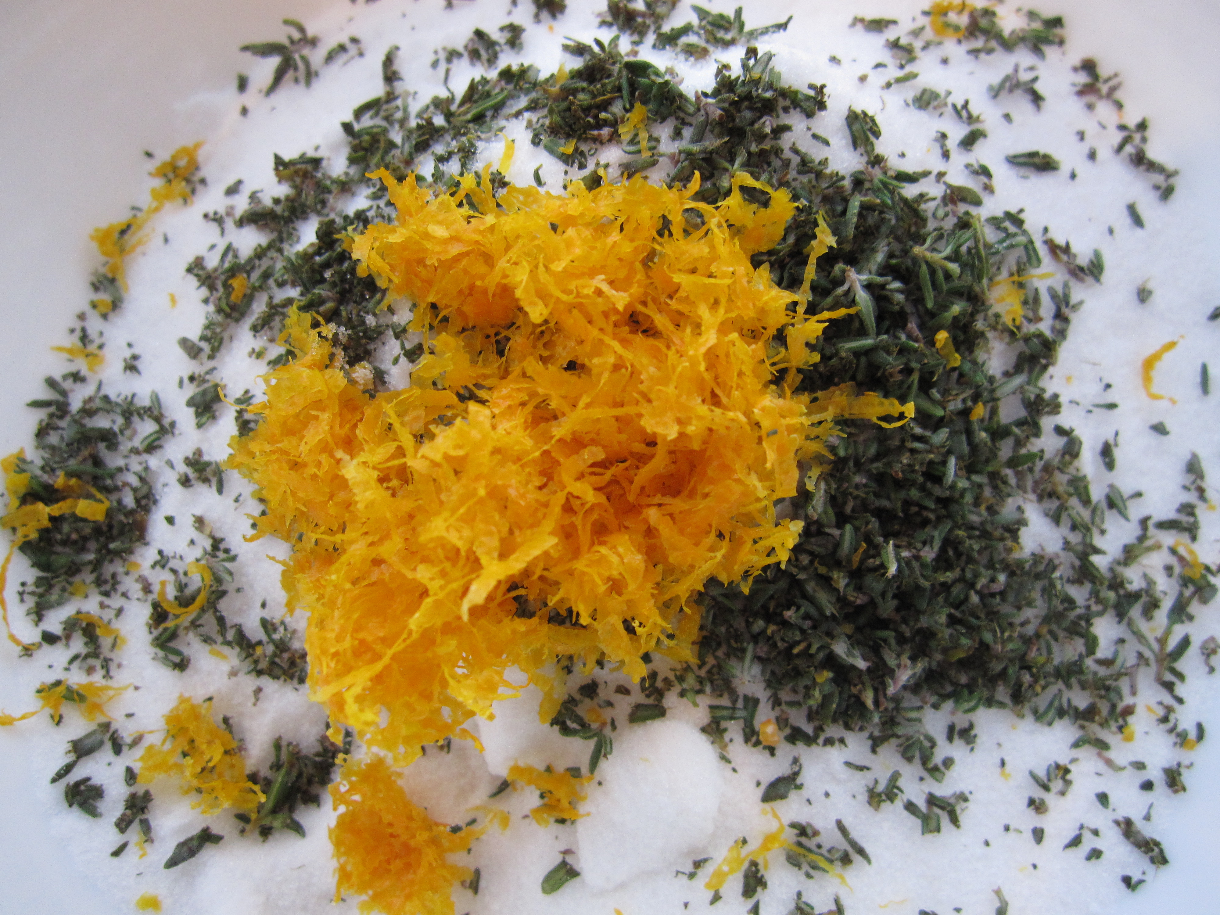 Orange zest, thyme, and sugar in a bowl, all rubbed together.