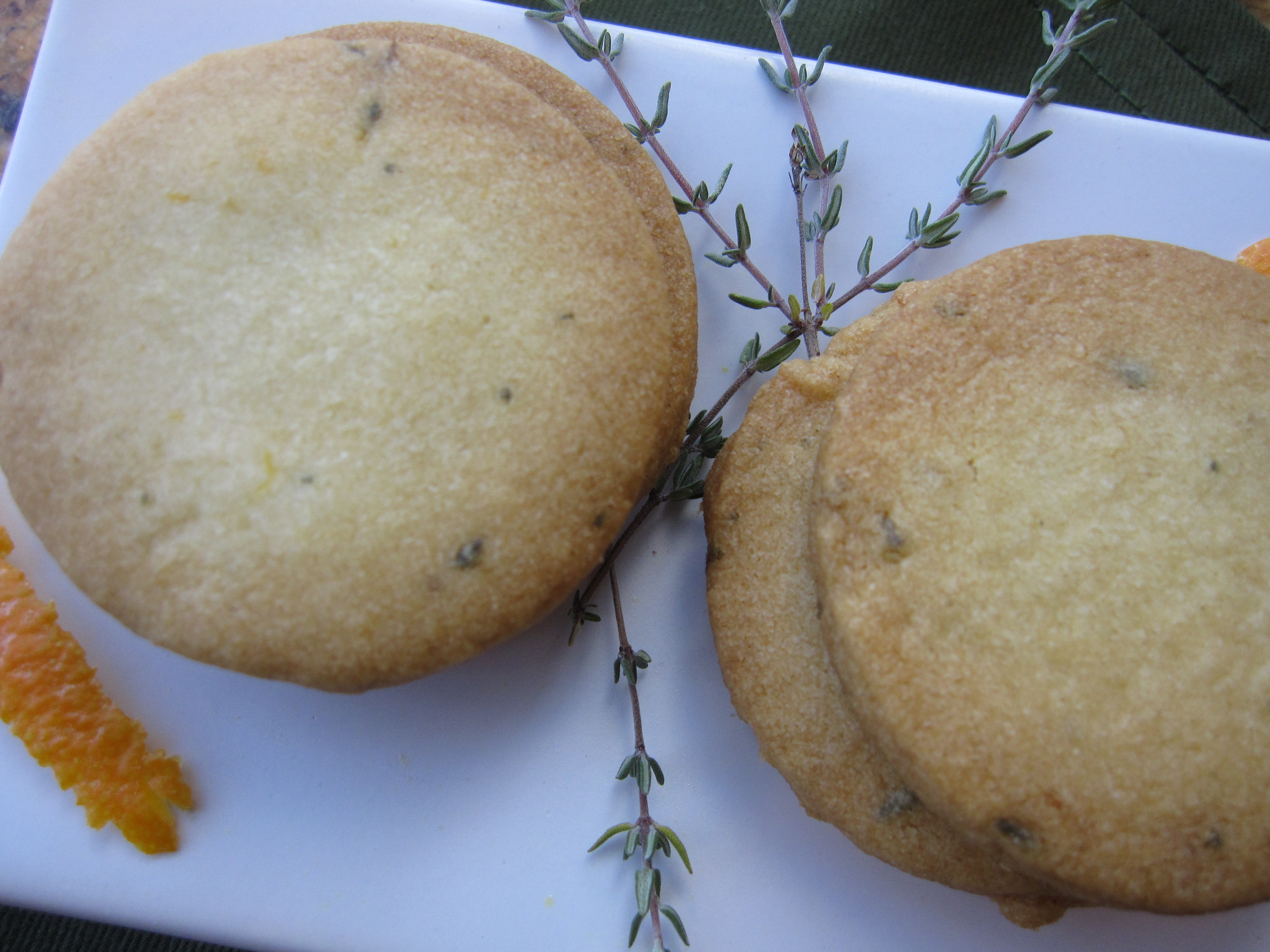 Baked Orange Thyme Cocktail Cookies with a fresh thyme garnish.