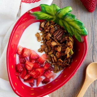 olive oil granola, yogurt and strawberries in strawberry bowl