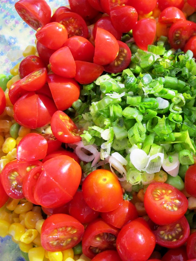 green onions and tomatoes in bowl unmixed corn salad