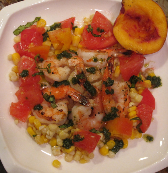 A serving of Warm Scallop and Shrimp Salad with a nectarine on the side.