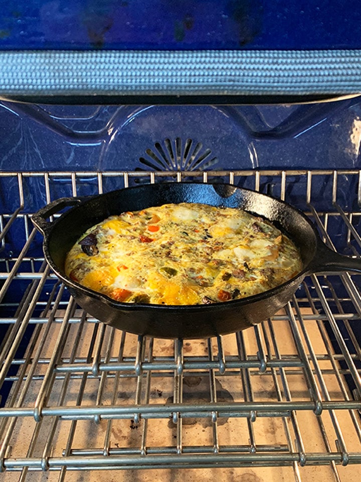 Frittata in a cast iron frying pan, baking in the oven.