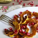roasted delicata squash with pomegranate on white plate
