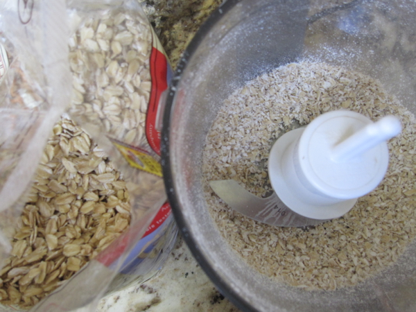 Oats being ground in a food processor.