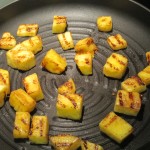 Pineapple chunks on a grill pan.