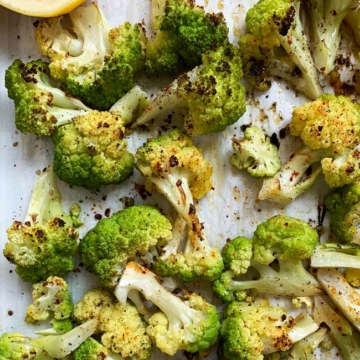 cooked cauliflower on parchment with lemon