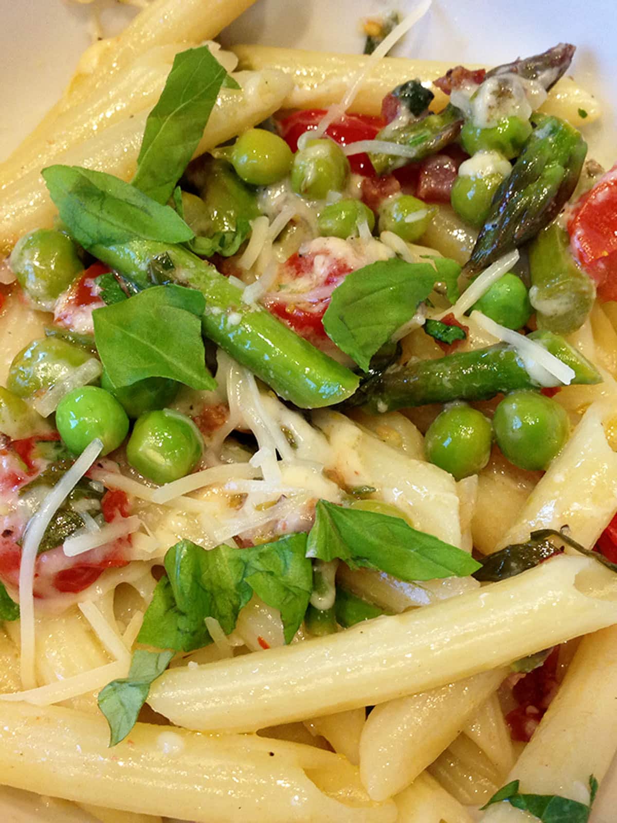 Close up of farmers' market pasta in a white bowl.