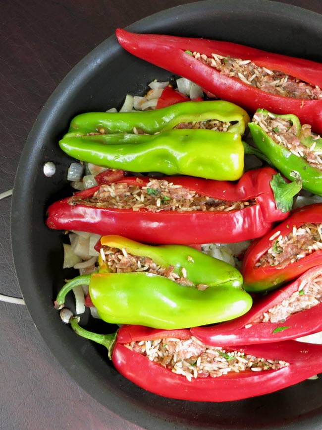 red and green stuffed Romano peppers in pan