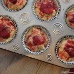 Roasted strawberry muffins in a muffin pan.