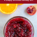 Pinterest image show jam on blue background with spoon and orange in the background.