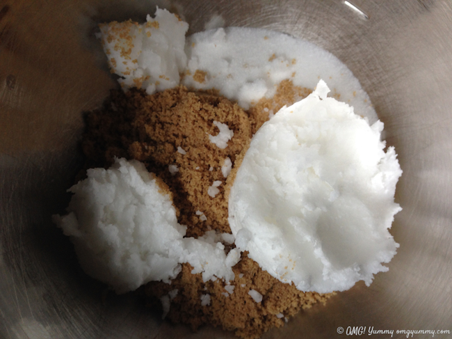 Brown and white sugar and coconut oil in a mixing bowl.