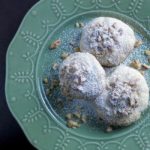 3 cookies on green plate with powdered sugar