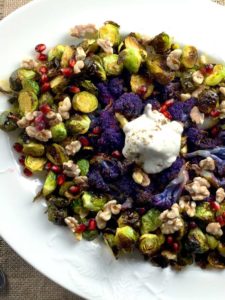 brussels sprouts and cauliflower on white plate with yogurt topping