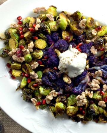 brussels sprouts and cauliflower on white plate with yogurt topping