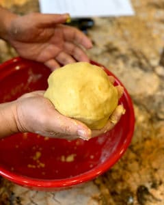 hand holding finished hamantaschen dough
