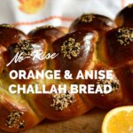 baked challah with orange and towel with oranges on it