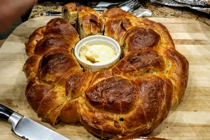 round challah loaf with butter in the center