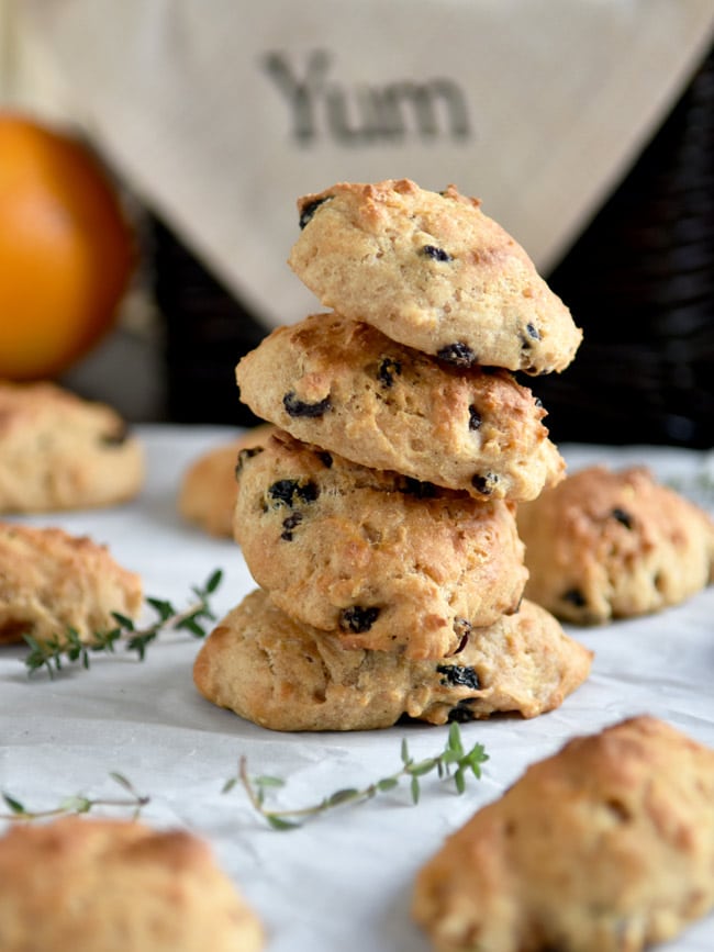 stacked irish soda biscuits on parchment with basket in the bkgd