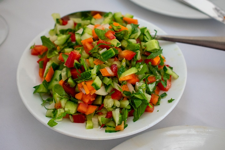 Chopped salad at the Uri Buri restaurant in Acre, Israel on a white plate.