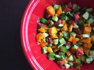 cucumber tomato salad in red bowl cropped for feature image size