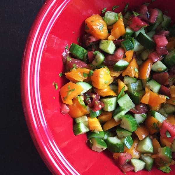 cucumber tomato salad in red bowl cropped for feature image size