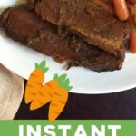 brisket on white plate with carrots and potatoes