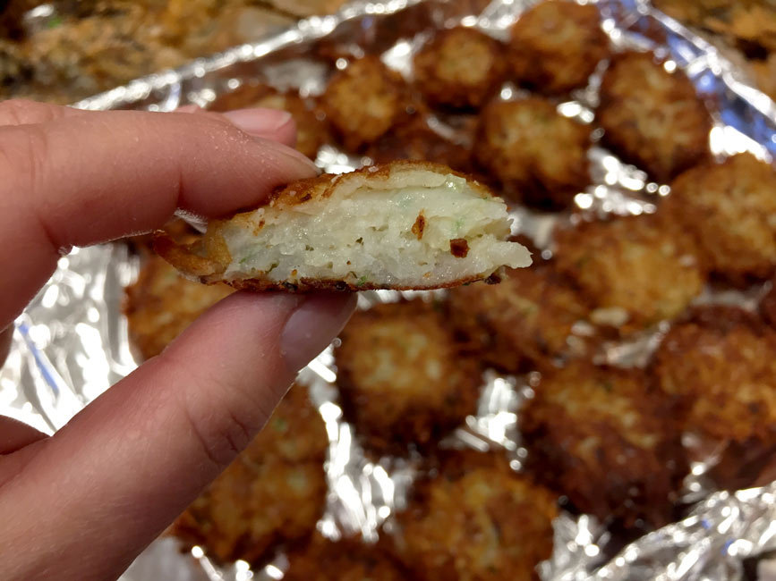 hand holding a cross section of latke
