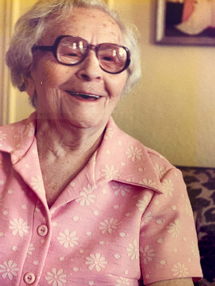 Grandma Annie smiling in a pink dress