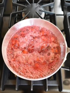 jam boiling on stovetop with white foam