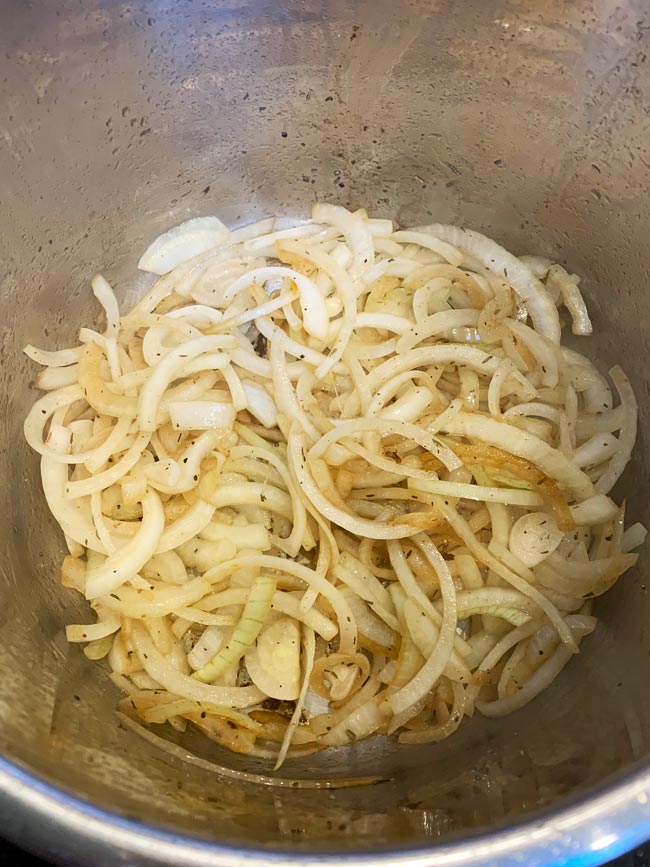 Sliced onions for pomegranate molasses brisket sautéing in the instant pot.