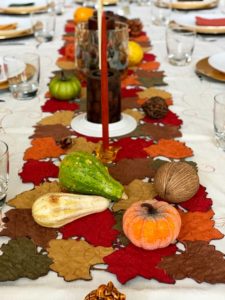 thanksgiving table set with candles and gourds