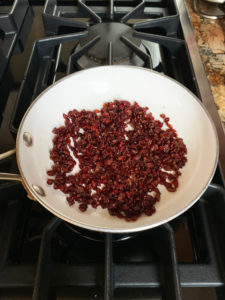 barberries sauteing in white fry pan