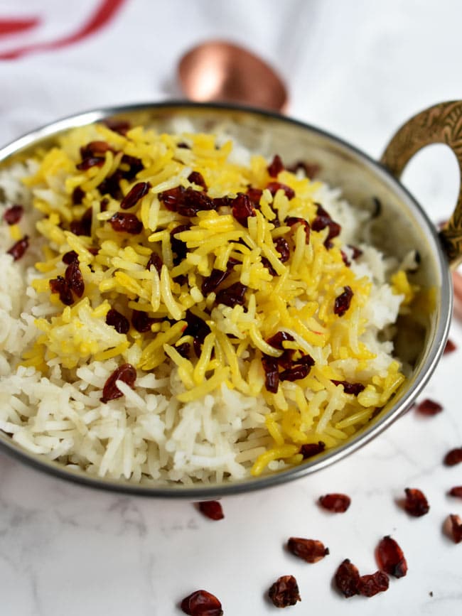 Close up view of saffron barberry studded basmati rice.