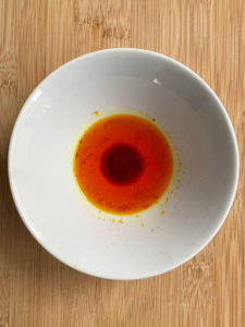 saffron soaking in water in white bowl