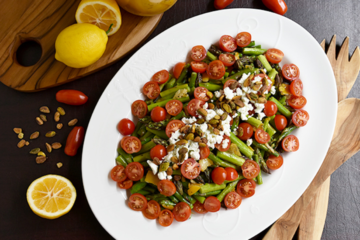 asparagus salad with tomatoes on white plate 