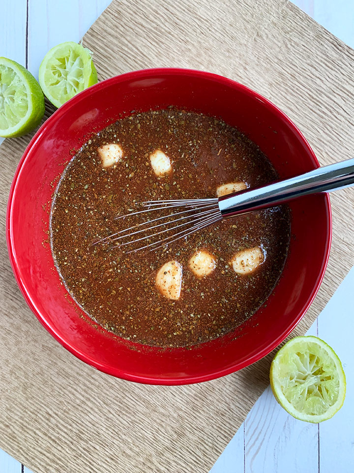 Mixed carnitas liquid whisked together, ready to pour on meat.