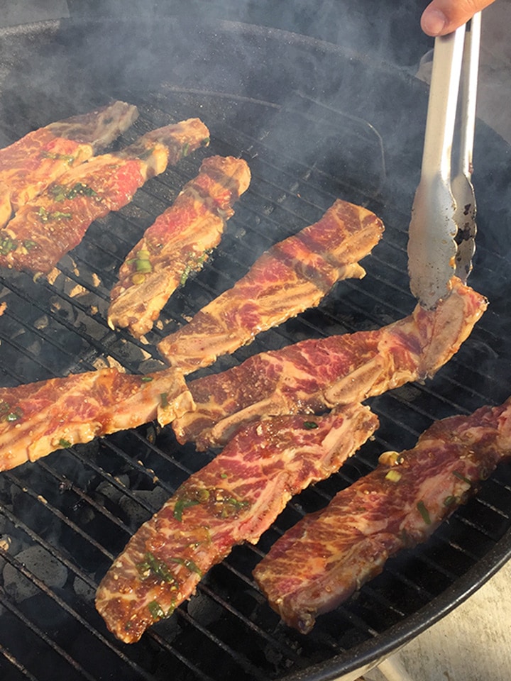 Korean short ribs (kalbi) on charcoal grill.