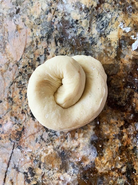 Challah dough coiled and ready to rise and bake on countertop.