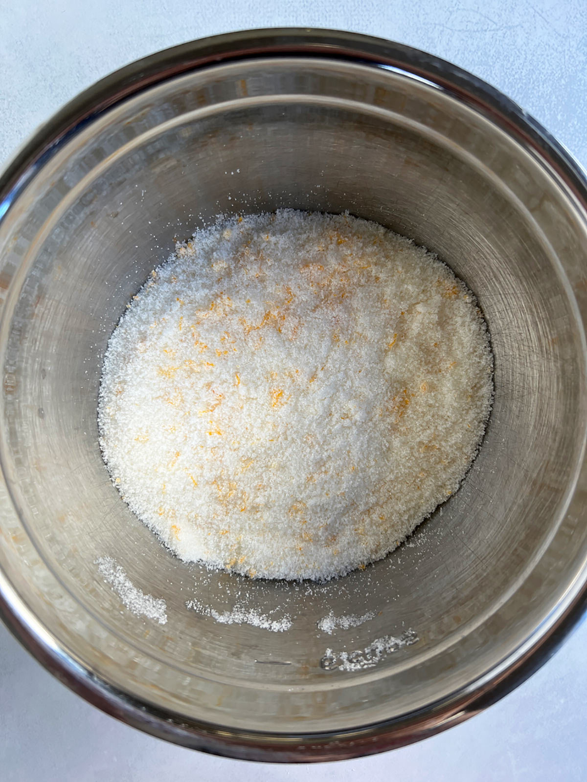 Orange zest mixed into granulated sugar.
