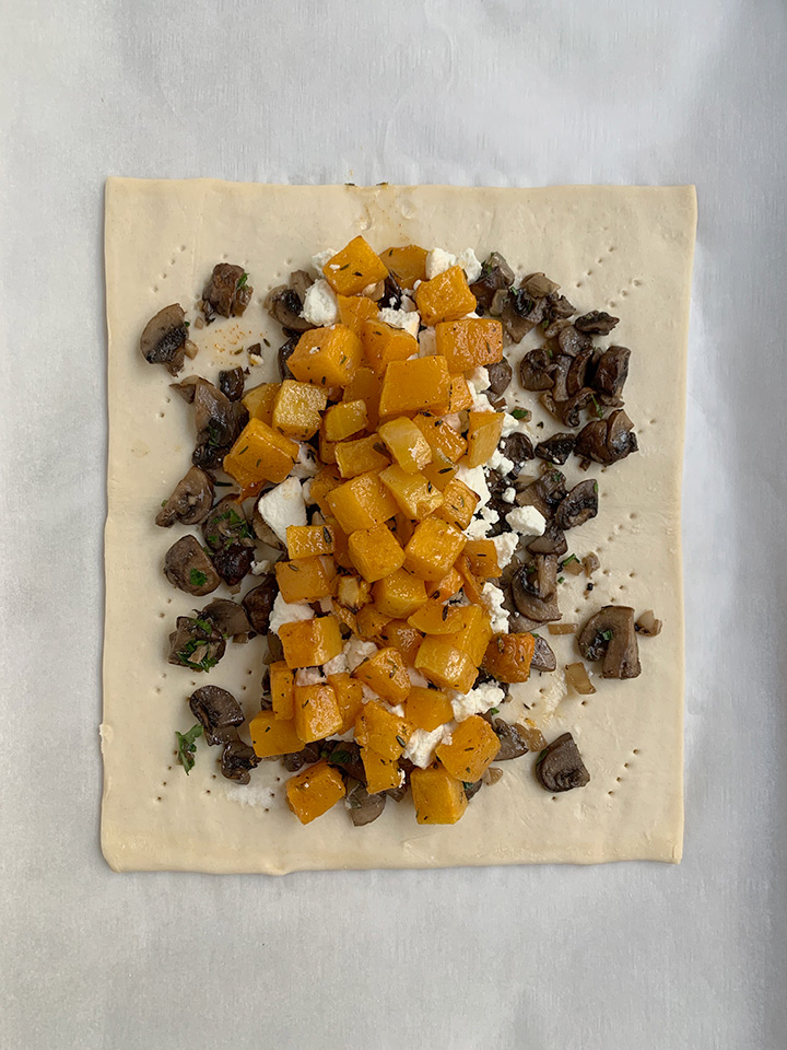 squash layered onto goat cheese and mushrooms on top of puff pastry