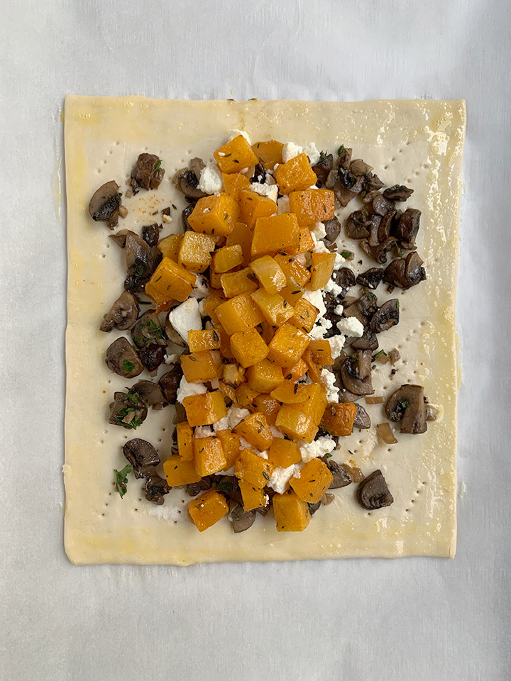 edges of puff pastry are brushed with egg wash