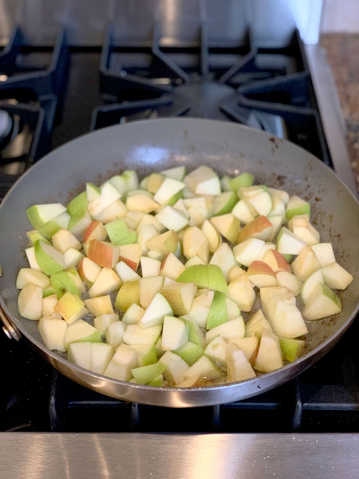 Sauteed apples in pan on stove top.