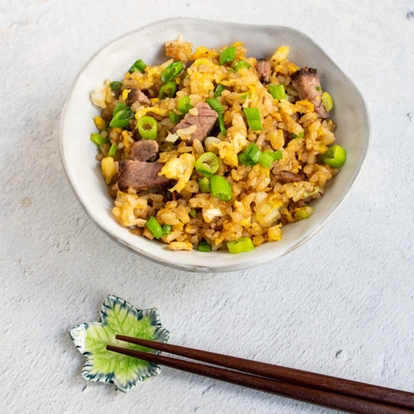 bowl of beef fried rice with wooden chop sticks